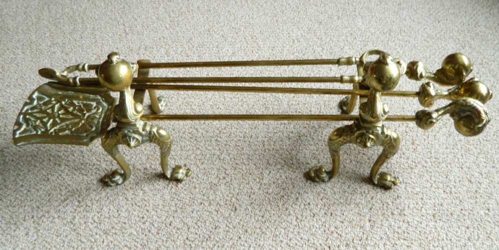 brass andirons with set of fire tools