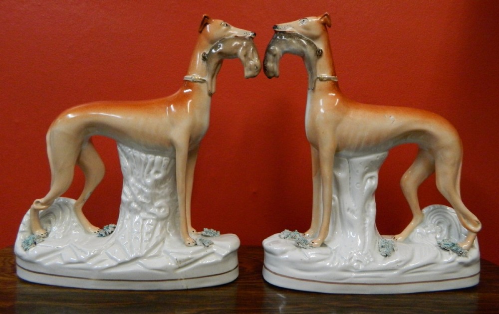 tall pair of staffordshire greyhounds with rabbits hares