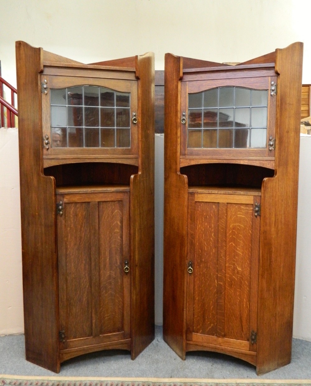 pair of oak arts crafts cabinets in the manner of liberty
